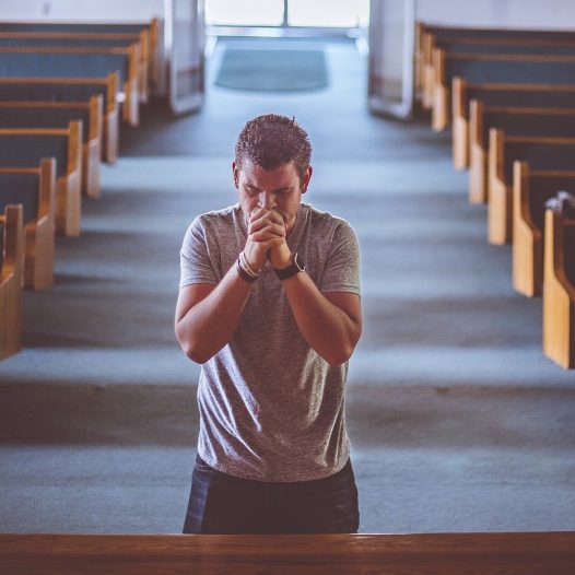 man praying church